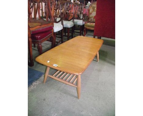 An Ercol light elm and beechwood occasional table of rectangular form with moulded outline, raised on simple splayed tapered 