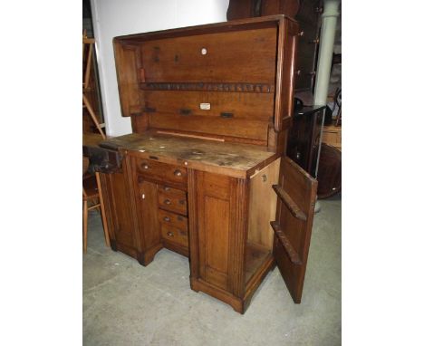A vintage oak framed carpenters work bench by Melhuish and Sons Tool Makers, Fetter Lane London, the panelled frame with hing