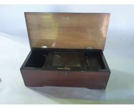 A late 19th century cylinder music box set within a hinged timber case with simulated rosewood finish and further inlaid deta