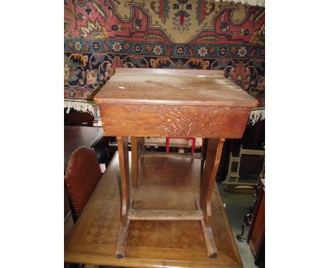 A vintage pitch pine child's school desk with cast iron fittings, hinged lid and shaped supports, raised on sledge feet 