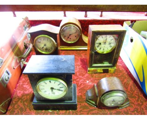 A Victorian black slate mantel clock with eight day timepiece, a further Napoleonic mantel clock in an oak case and three oth