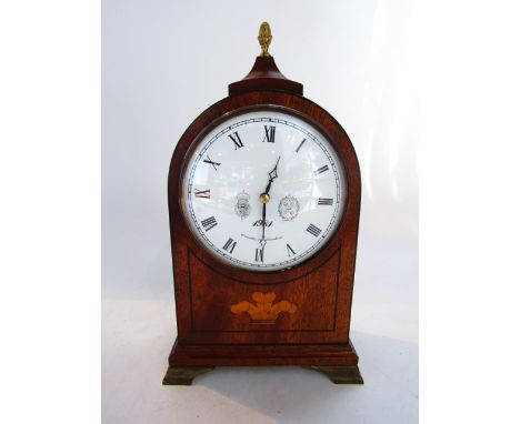 A Comitti Regency style mantel clock in a mahogany case with fleur de lys detail and lion mask handles, enclosing an eight da
