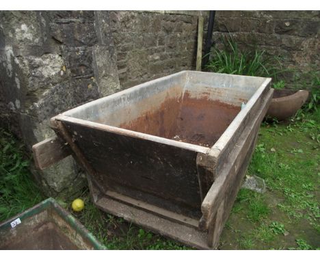 A vintage wooden framed and tin lined trough/bin of rectangular form with tapered sides and carrying supports, the receptacle
