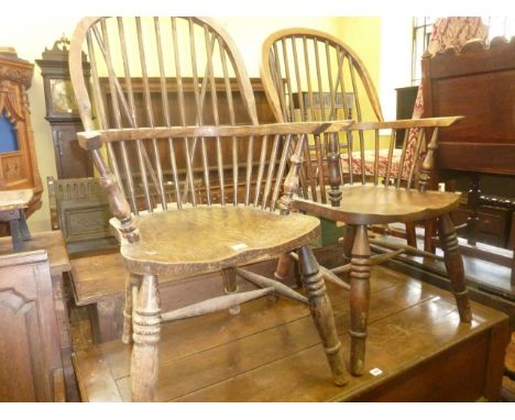 A pair of Windsor hoop and stick back elbow chairs in elm, ash and beech raised on ring turned and tapered supports, untied b