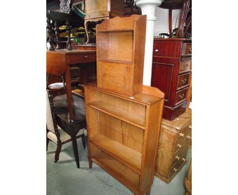 An arts and crafts style light oak freestanding open bookcase with three adjustable shelves, the shallow raised back with cha