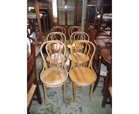 A set of six light beechwood Bentwood café chairs with circular panelled seats 