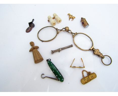 A Victorian style lantern charm, hinged compartment set with a red stone, the base inset with a white hardstone, in gilt meta
