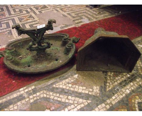 A 19th century cast iron boot scraper with c-scroll outline, together with a reclaimed cast iron drain water hopper