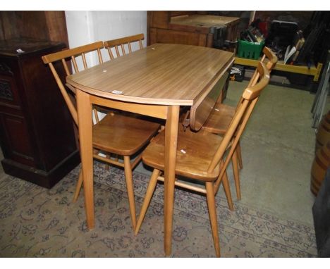 A set of four vintage Ercol elm and beechwood stickback kitchen chairs raised on turned, tapered and splayed supports, each b