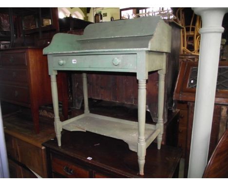 A 19th century pine wash stand, with raised three quarter gallery over a frieze drawer and turned supports, united by a platf