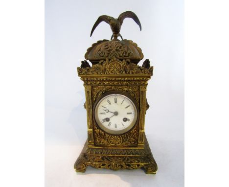 A Victorian cast brass mantel clock, the square cut case heavily detailed with foliate panels enclosing an eight day striking