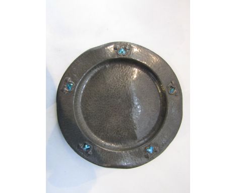 A Liberty & Co pewter dish model number 0109, attributed to Archibald Knox, the broad rim decorated with heart shaped turquoi