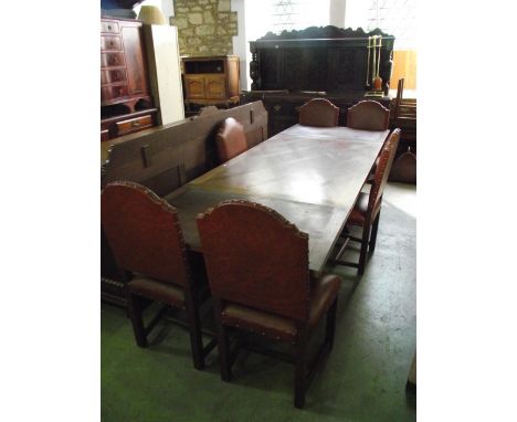 A substantial medium oak dining room suite comprising: draw leaf dining table raised on a pair of slab end column supports wi