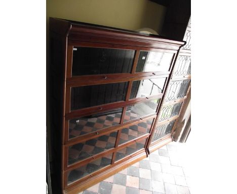 A Globe Wernicke style floor standing five sectional stacking library bookcase enclosed by twin glazed and moulded rectangula