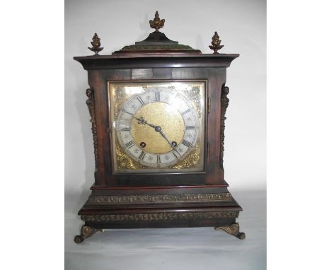 A Georgian style bracket clock with square brass dial and silvered chapter ring, the case with applied gilt brass and other d