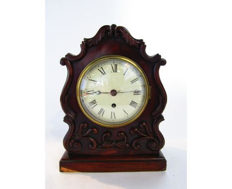 A Regency mahogany mantel clock with shaped case and applied anthemion detail enclosing an eight day single train fusee movem