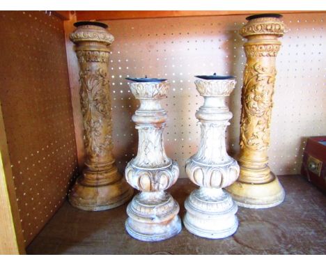 A pair of decorative plaster (simulated wood) candle sticks of classical form with egg and dart, acanthus and scale moulded d