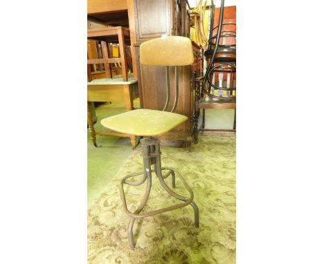 A vintage industrial style machinist/typists type chair with adjustable revolving faux leather pad seat and curved back pad s