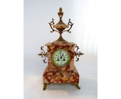 A mid Victorian polished marble mantel clock with applied brass fittings set beneath a shaped urn, the painted dial enclosing