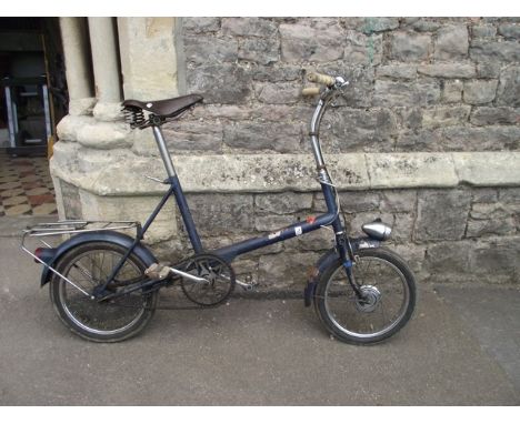 A vintage Raleigh ladies bicycle with tubular steel frame, leather Brooks saddle and bag carrying rack