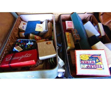 Two vintage suitcases containing a quantity of 20th century playing cards, a quantity of glass marbles, games to include The 