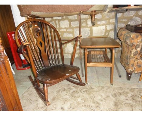 A Ercol dark stained low hoop and stick back rocking chair with central pierced fleur-de-lys splat, together with a mid-20th 