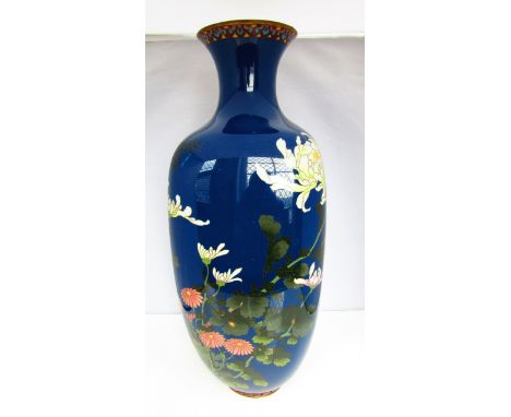 A Chinese cloisonne enamel vase of tapering squared form with drawn neck and rim, the deep blue ground decorated with flowers