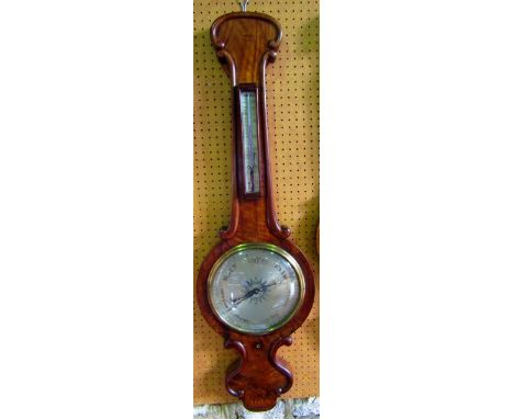 A substantial mid Victorian wheel barometer with figured mahogany case and applied moulded detail enclosing two silvered dial