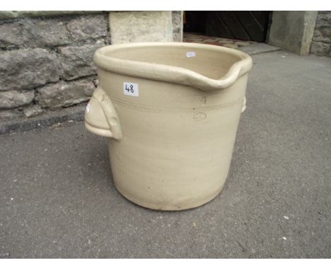 A vintage cream glazed stoneware pail of circular form with pouring lip, pronounced moulded cup handles and simple beaded inc