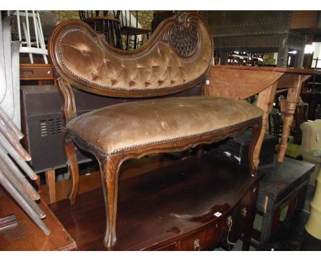 A small Victorian style two seat bedroom/parlour sofa with upholstered seat and button back within a shaped carved and moulde