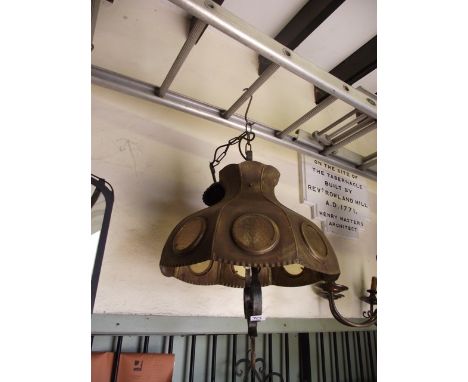 An unusual hanging ceiling light, the scroll work stem supporting a sheet brass shade with circular glass panels