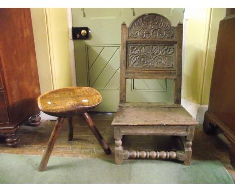 A primitive milking stool with saddle shaped seat and stick supports, together with an early oak panelled back chair with car