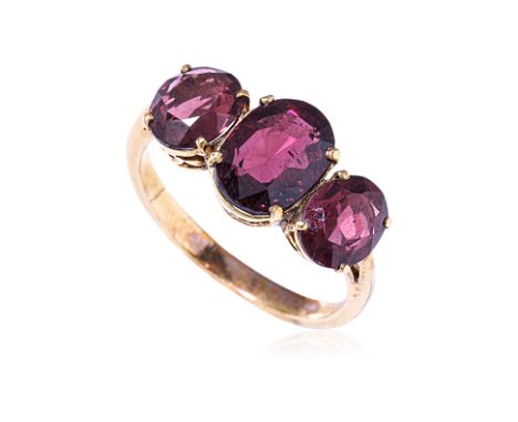A GARNET THREE STONE RING
Featuring three oval cut garnets totalling approximately 4.5 Cts, mounted in an unmarked yellow gol