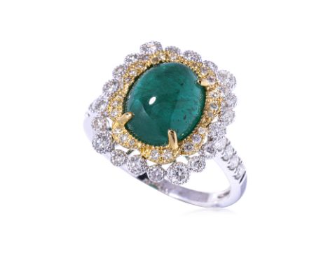 AN EMERALD CABOCHON AND DIAMOND RING
Featuring an emerald cabochon weighing approximately 3.686 Cts (marked), mounted in a tw