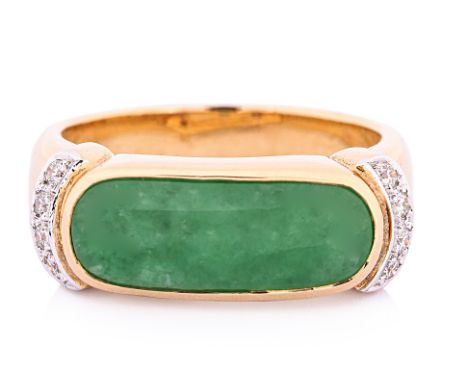 A JADE AND DIAMOND SADDLE RING Featuring a jade piece measuring approximately 15 x 6 mm, mounted in a yellow gold setting mar