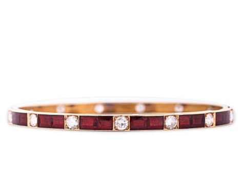 A DIAMOND AND ENAMEL BANGLE
Set with 15 round brilliant cut diamonds totalling approximately 2.50cts, between red enamel spac