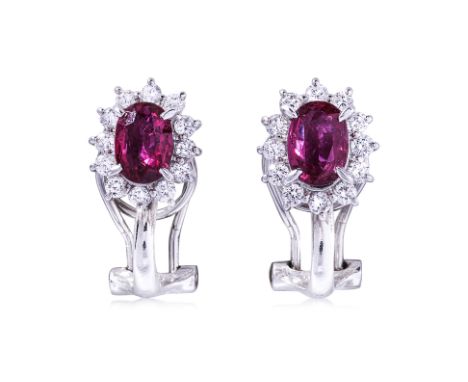 A PAIR OF RUBY AND DIAMOND CLUSTER CLIP EARRINGS the oval rubies weighing approximately 0.55cts and 0.59cts respectively (mar