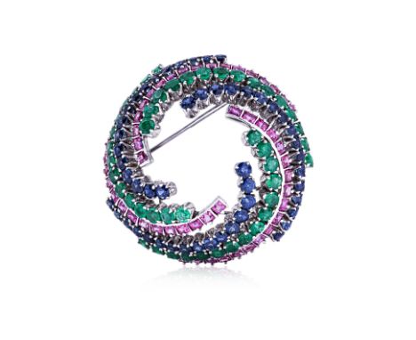 A SAPPHIRE, RUBY AND EMERALD BROOCH Set with alternating rows in a swirl design, in white gold setting marked '12k' 4.5cm dia