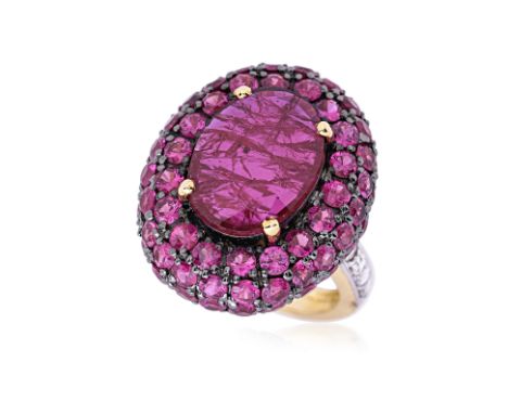 A RUBY AND DIAMOND RING Featuring an oval shaped ruby weighing approximately 4.85 Cts, mounted in an 18K mixed gold setting, 