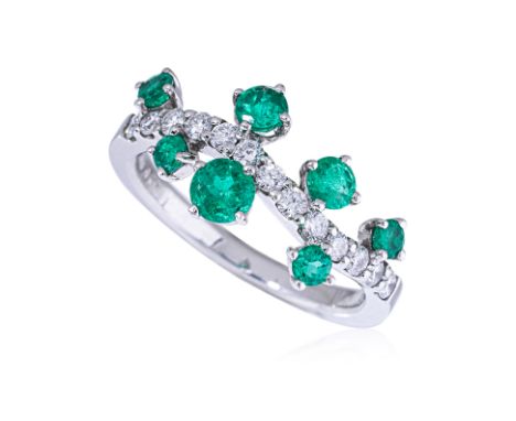 AN EMERALD AND DIAMOND RING
Set with variously sized round cut emeralds, totalling approximately 0.77cts (marked); and round 