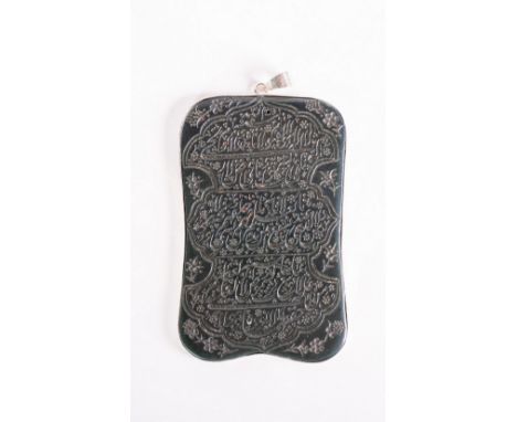 Islamic Art A spinach jade talismanic pendant decorated with inscriptions and later silver framePersia, 19th century  . . Cm 