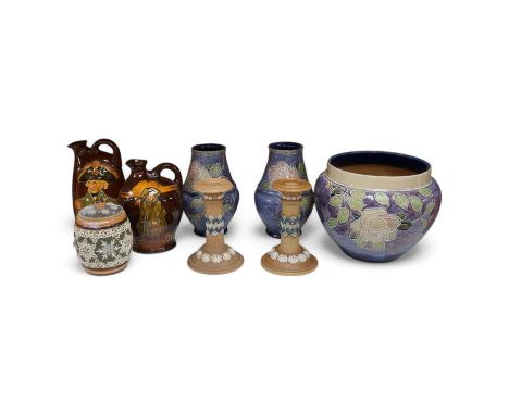 A collection of Doulton stoneware to include Nelson flask, pair of candlesticks and jardiniere, largest 22cm high. Condition 