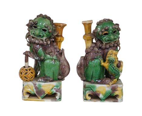 A pair of Chinese Sancai glazed lion joss stick holders, 18th century, 17cm high. Condition - some restoration