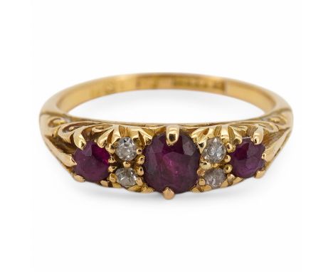 An Edwardian 18ct gold, three stone ruby and four stone diamond set half hoop ring, size K, gross weight 3.4 grams. Condition