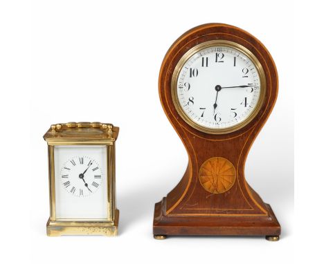 An Edwardian inlaid mahogany balloon clock and a brass cased carriage timepiece, largest 23cm high. Condition - fair, unteste
