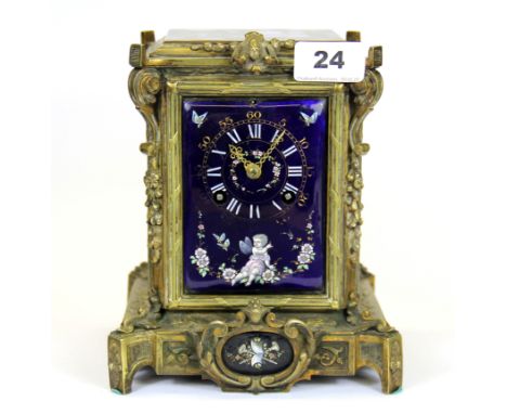A 19th Century French brass mantle clock with Limoges panels and striking movement, H. 19cm.