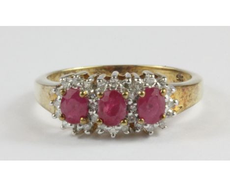 A 9ct yellow gold ruby and diamond triple cluster ring, (N.5).