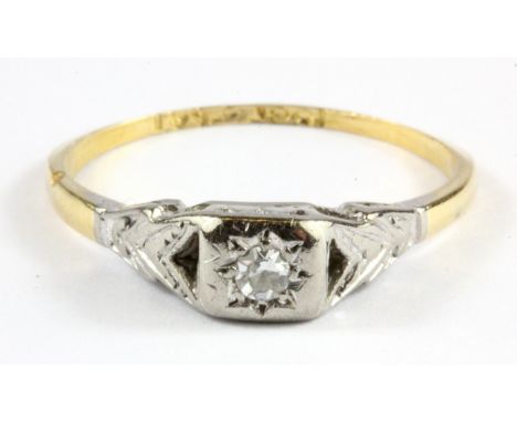 An 18ct yellow gold and platinum (stamped plat and 18ct) diamond set solitaire ring, (L).