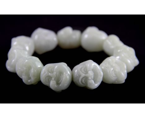 A Chinese Buddhist prayer bracelet of carved jadeite jade happy Buddha heads, bead W. 2cm.