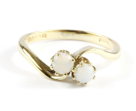 A 9ct yellow gold opal set crossover ring, (N).